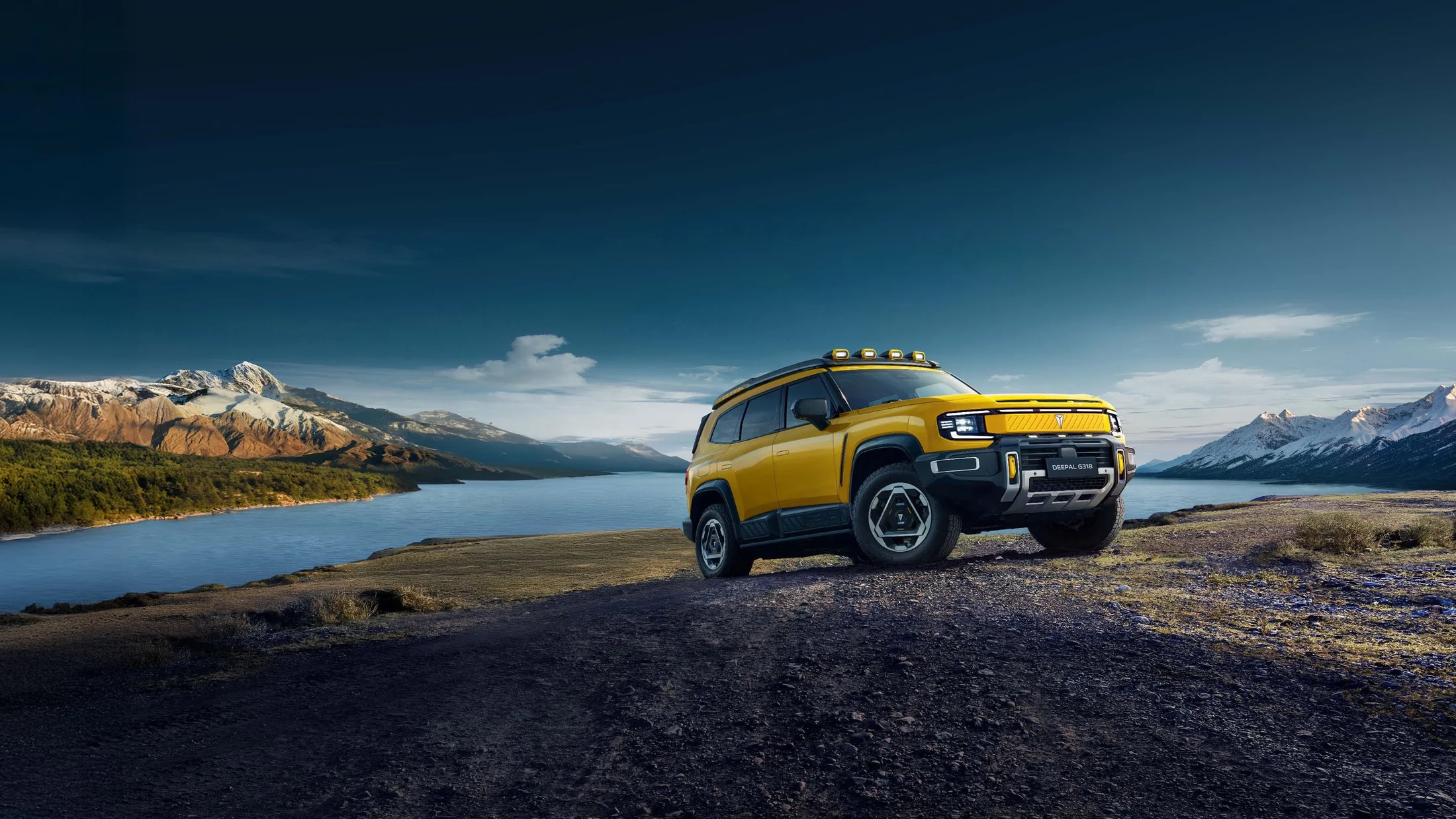 Yellow Deepal G318 beside a mountain lake